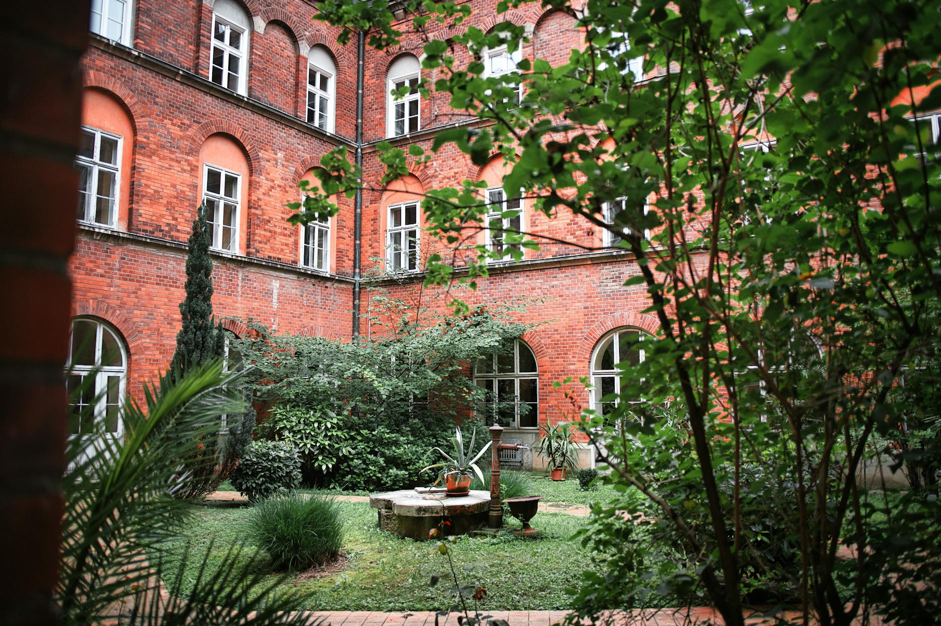 Zaciszny dziedziniec otoczony ceglanymi kamienicami w Mariborze